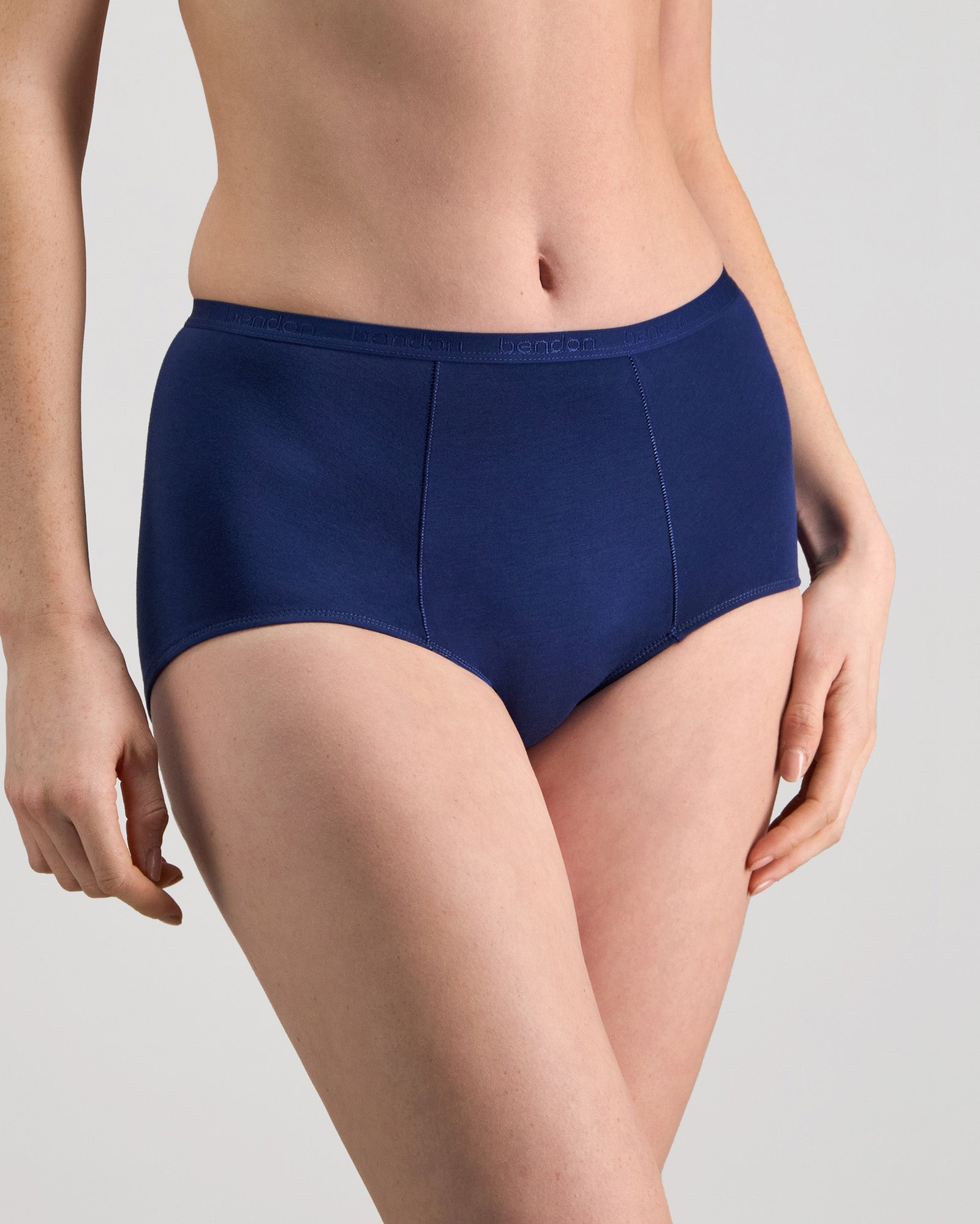Model wears Body Cotton Full Brief in Medieval Blue. On body side view