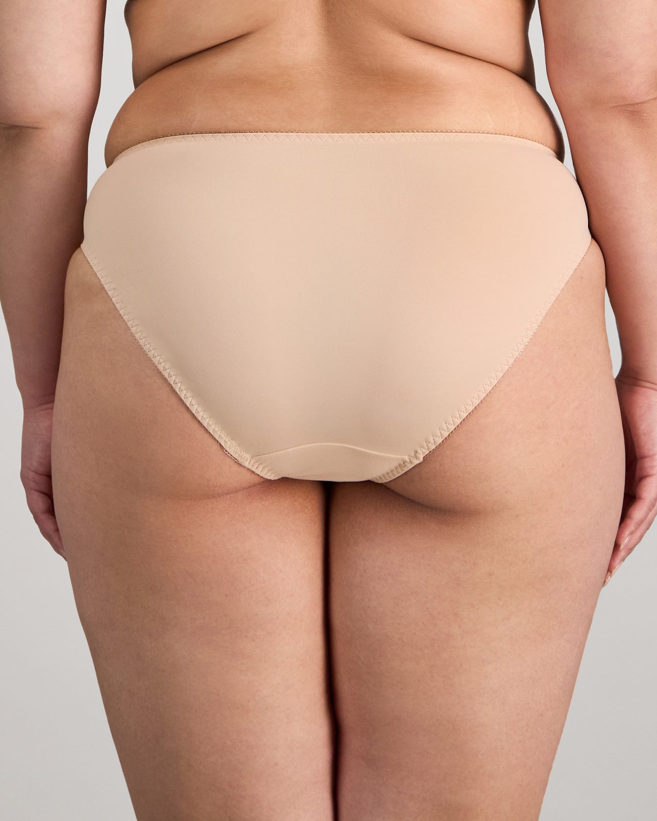 Model wears Coral High Cut Brief in LATTE. On body back view