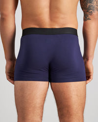 Model wears Everyday Essential Mens Trunk in PEACOAT. On body back view