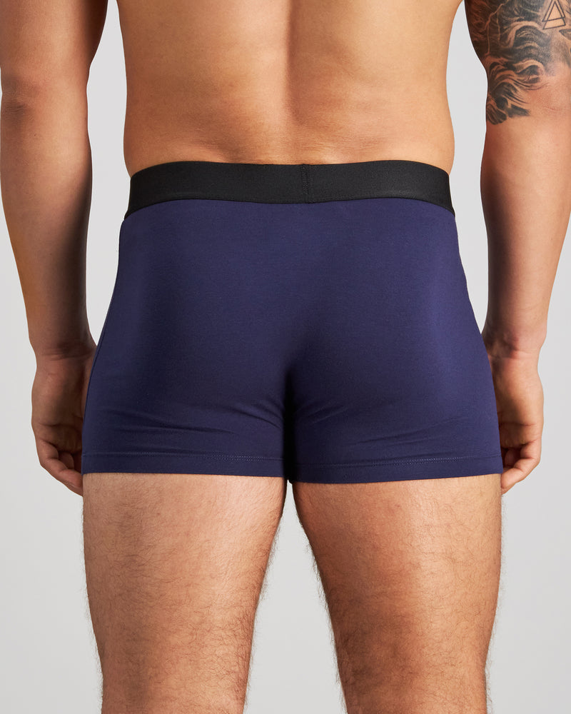 Model wears Everyday Essential Mens Trunk in PEACOAT. On body back view