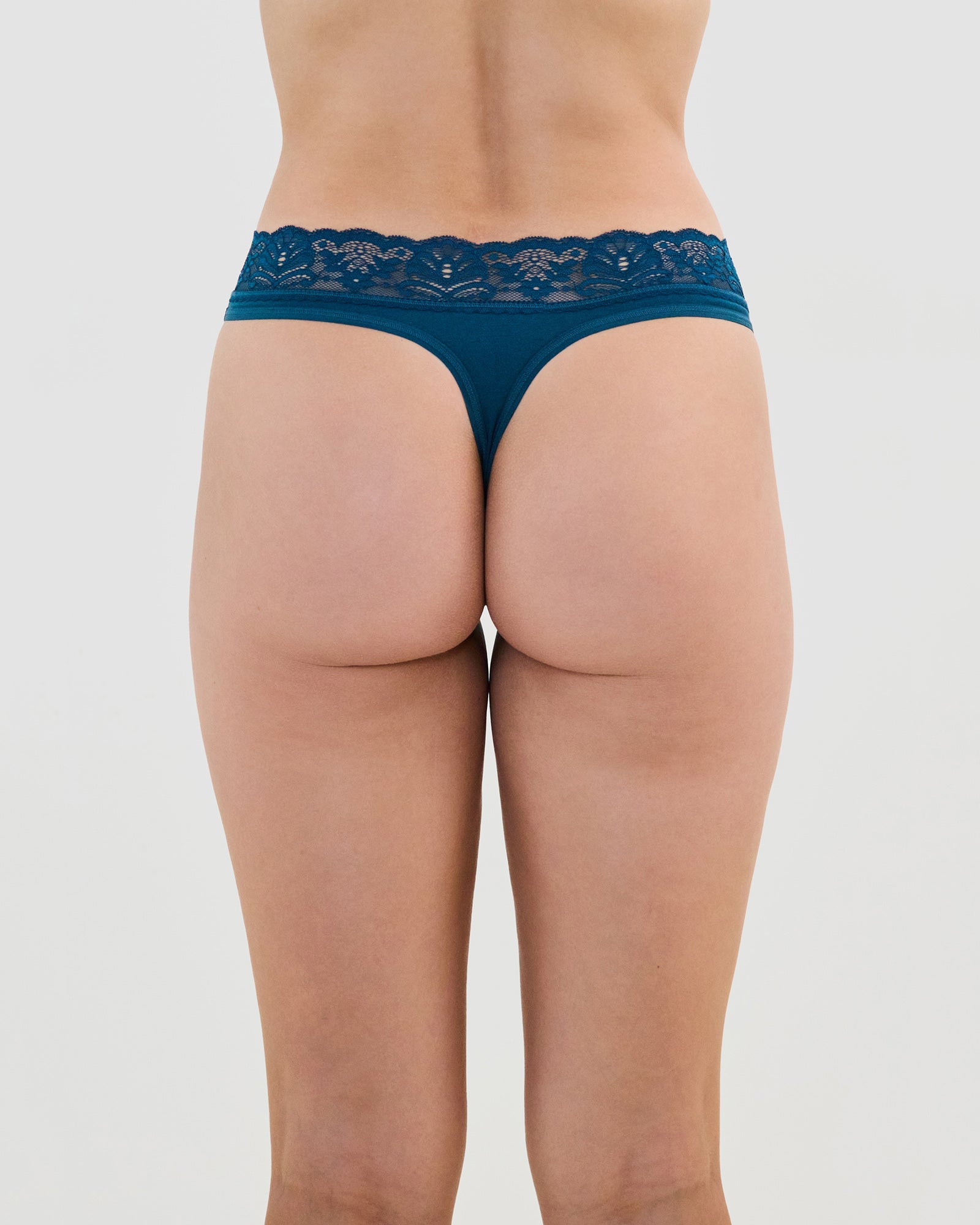 Model wears Cotton And Lace Thong in REFLECTING POND. On body back view
