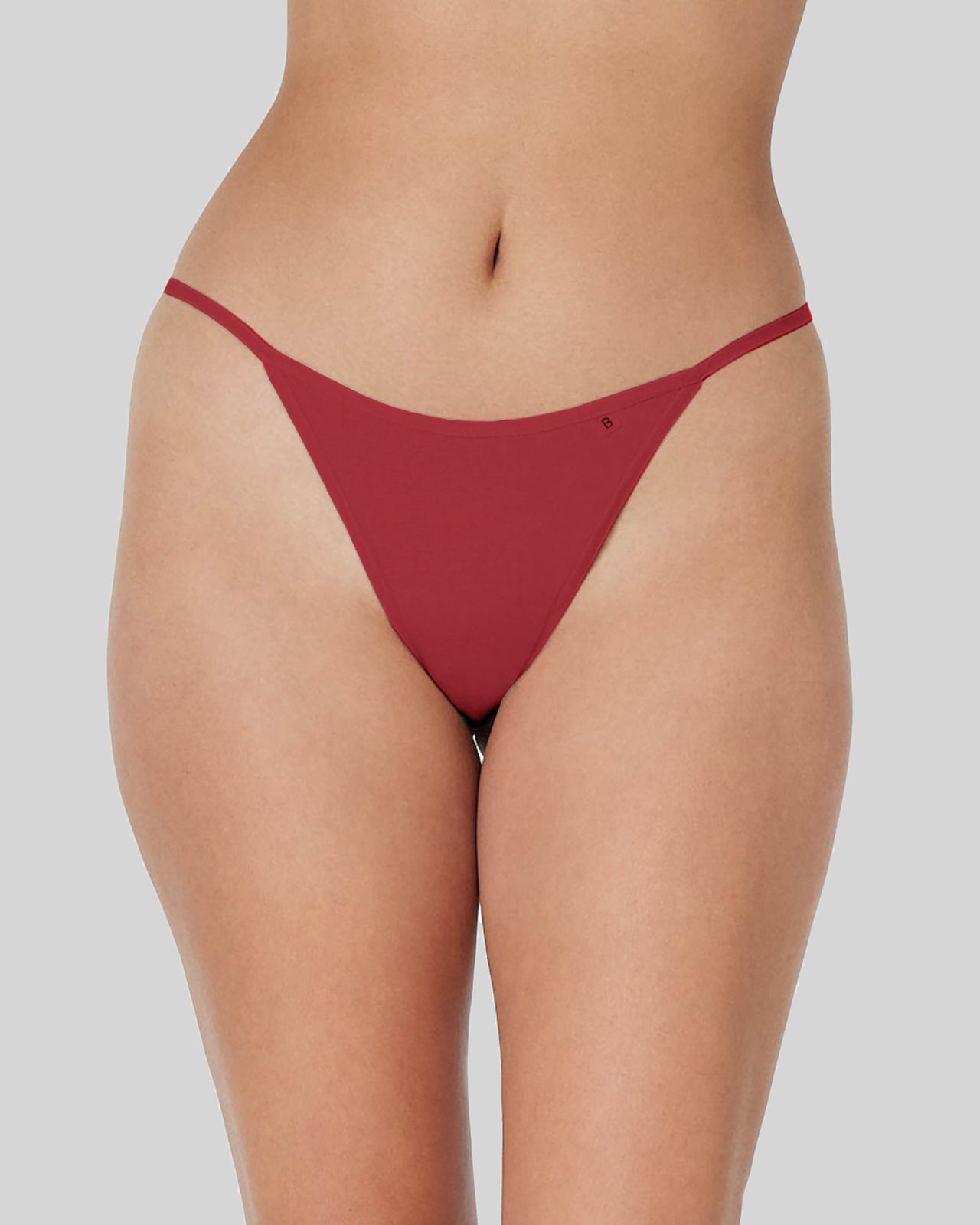Model wears Clemence Thong in JESTER RED. On body front view