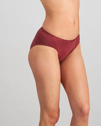 Model wears Body Cotton Bikini in OXBLOOD RED. On body side view