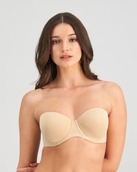 Model wears Sculptress Strapless Bra in LATTE. On body front view