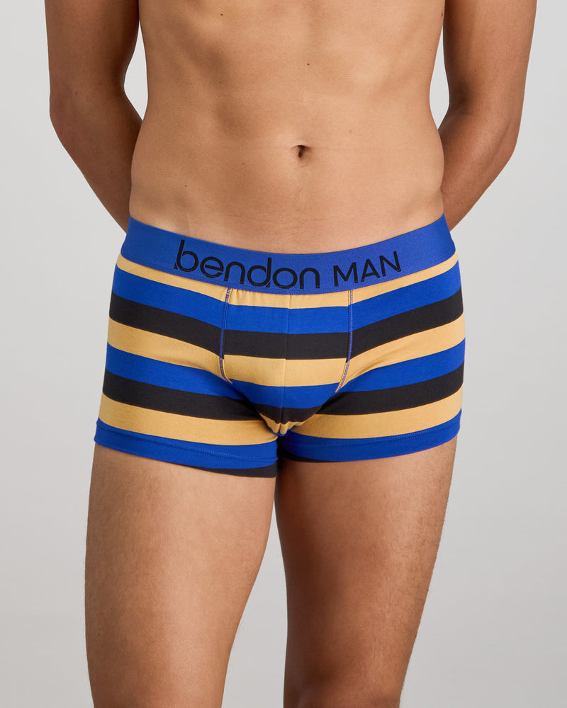 Model wears Rugby Stripe Mens Trunk in BLACK/SURF/OAK BUFF. On body front view