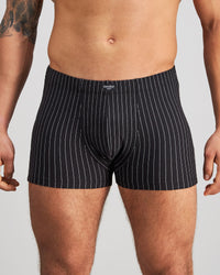 Model wears Cotton Stretch Mens Trunk in BLACK PINSTRIPE. On body front view