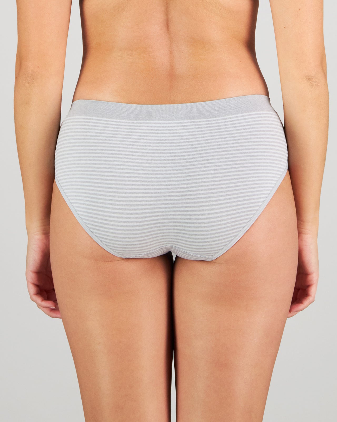 Model wears Simply Seamless Boyshort in GREY MARL/WHITE STRIPE. On body back view