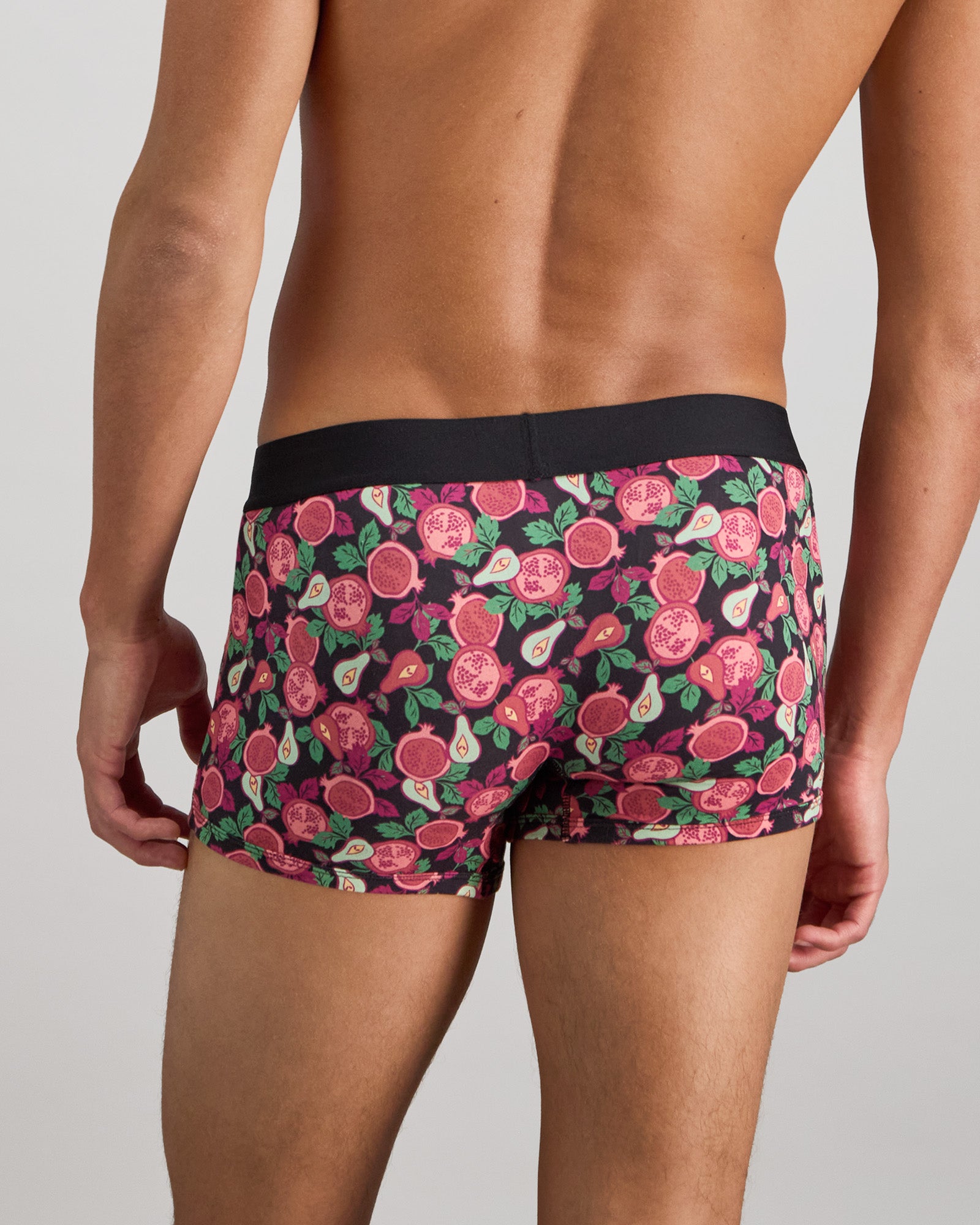 Model wears Retros Print Mens Trunk in SUMMER FRUITS PRINT. On body back view