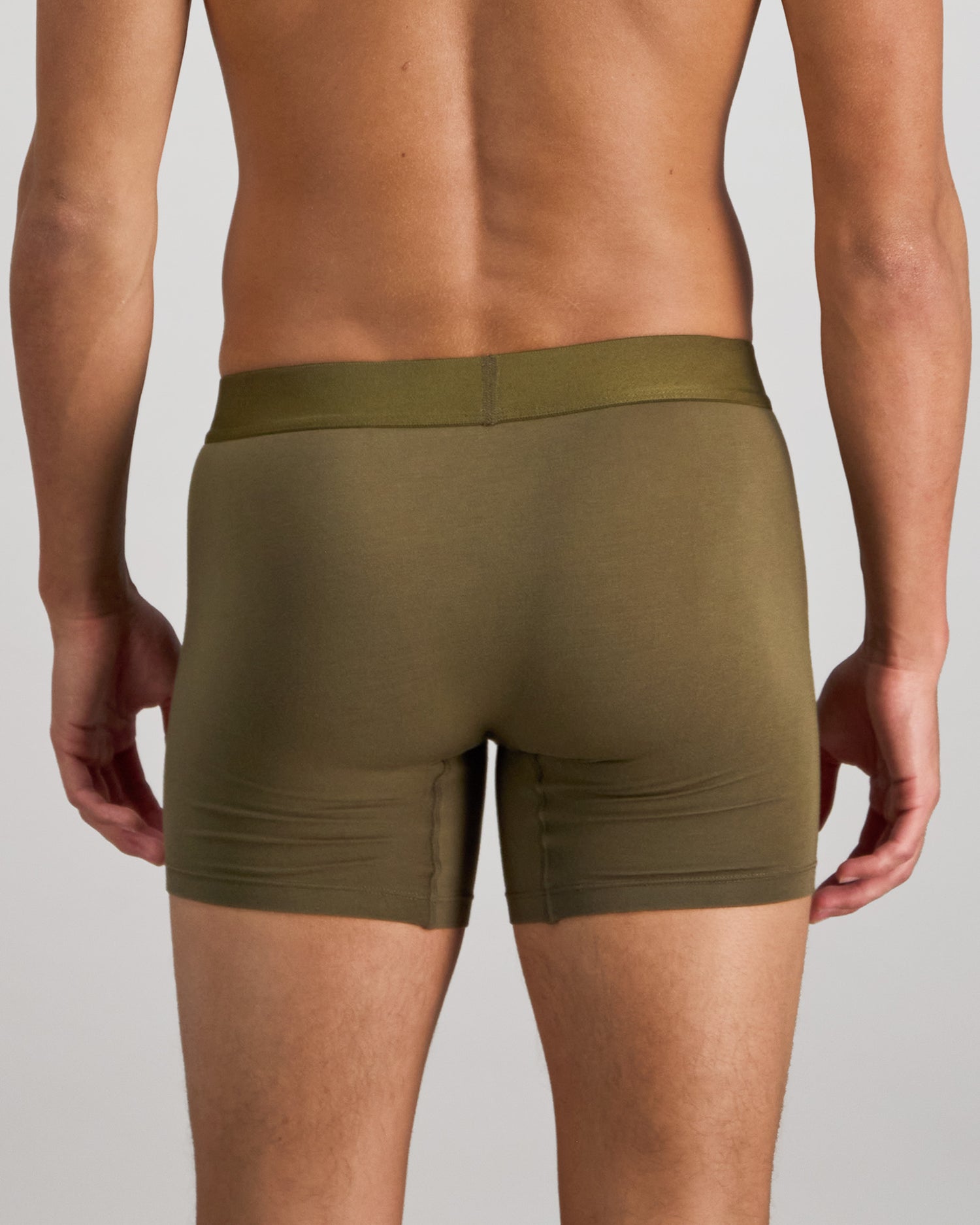 Model wears Bamboo Mens Trunk in DARK OLIVE. On body back view