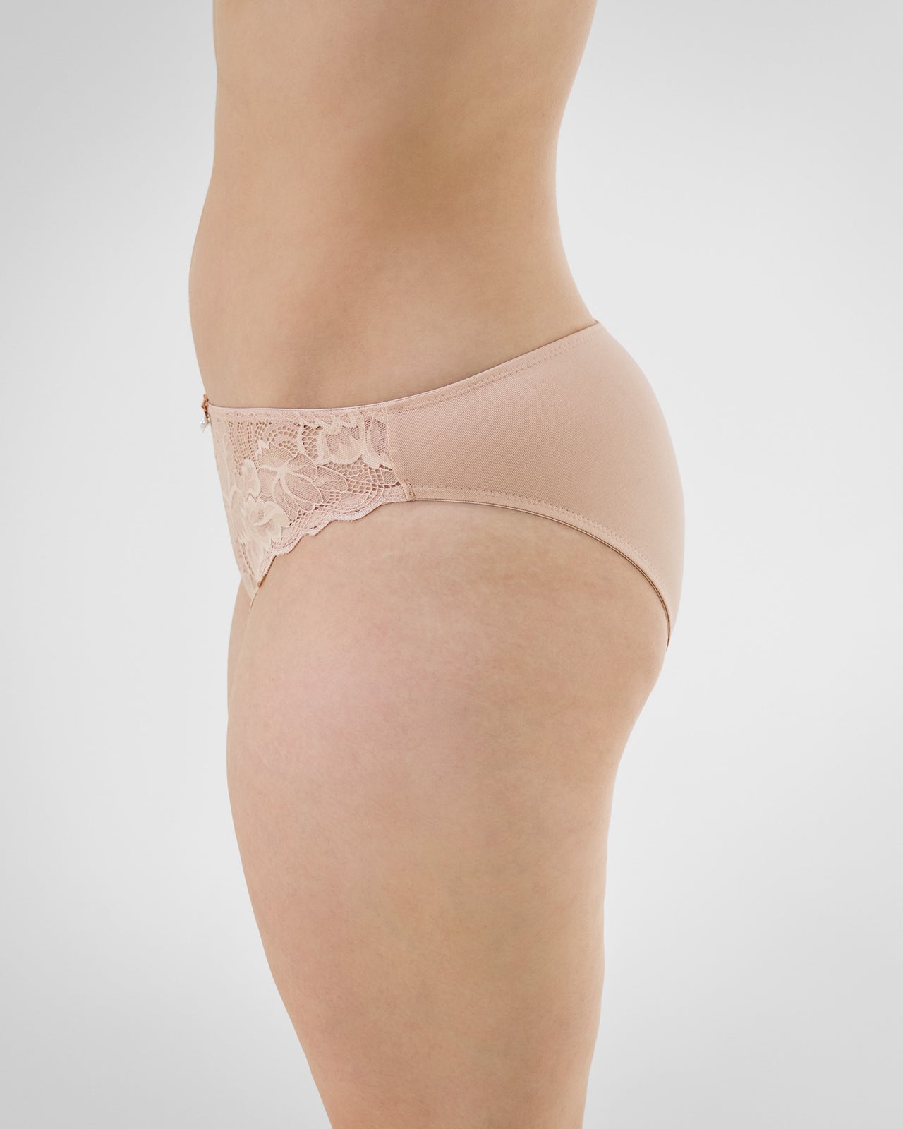 Model wears Embrace Bikini in LATTE. On body side view