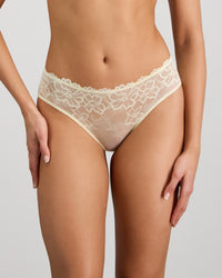 Model wears Lacey Bikini in TRANSPARENT YELLOW. On body front view