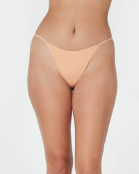 Model wears Clemence Thong in LATTE. On body front view