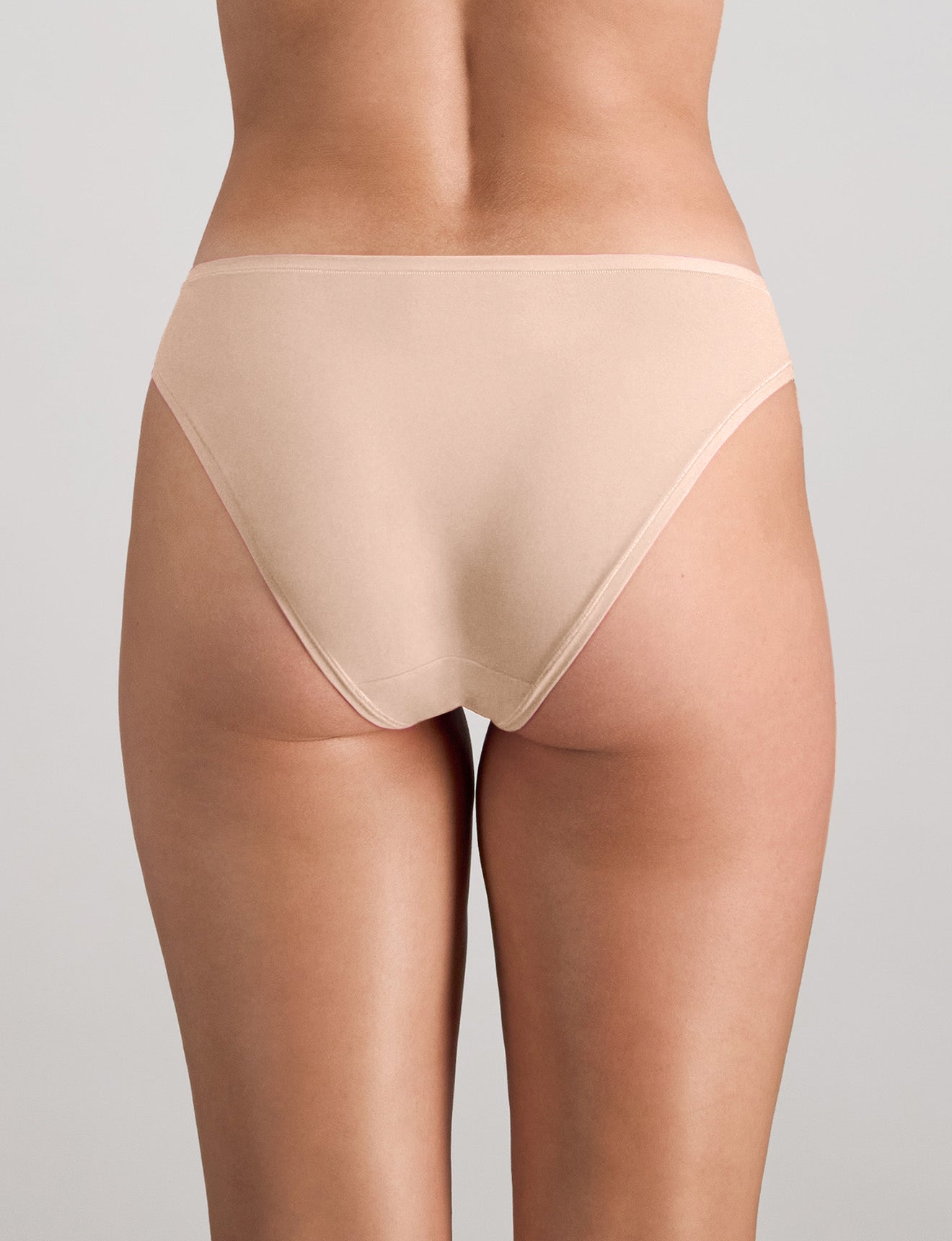 Model wears Extra-Ordinary Bikini Brief in LATTE. On body back view