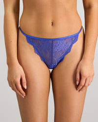 Model wears Midnight Muse Thong in DAZZLING BLUE. On body front view