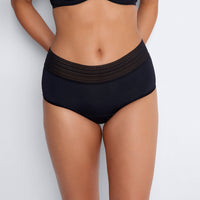 Model wears Flo Heavy Full Brief in BLACK. On body front view