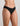 Model wears Extra-Ordinary Bikini Brief in BLACK. On body side view