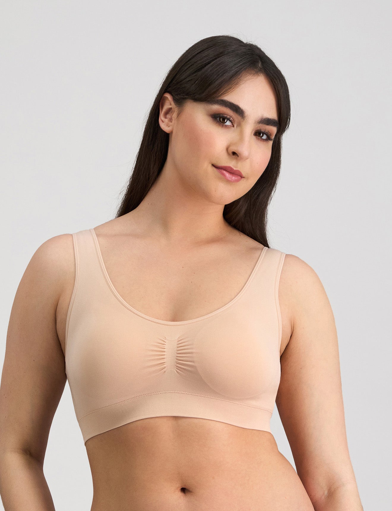 Model wears Bendon Essentials Strapless Bra in LATTE. On body front view