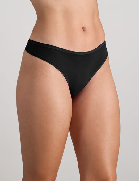 Model wears Extra-Ordinary Thong in BLACK. On body side view