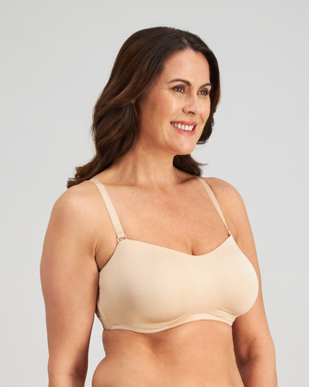 Model wears Bendon Bare Non Padded Strapless Bra in LATTE. On body side view