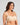Model wears Bendon Bare Non Padded Strapless Bra in LATTE. On body side view