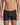 Model wears Cotton Stretch Mens Trunk in BLACK PINSTRIPE. On body front view
