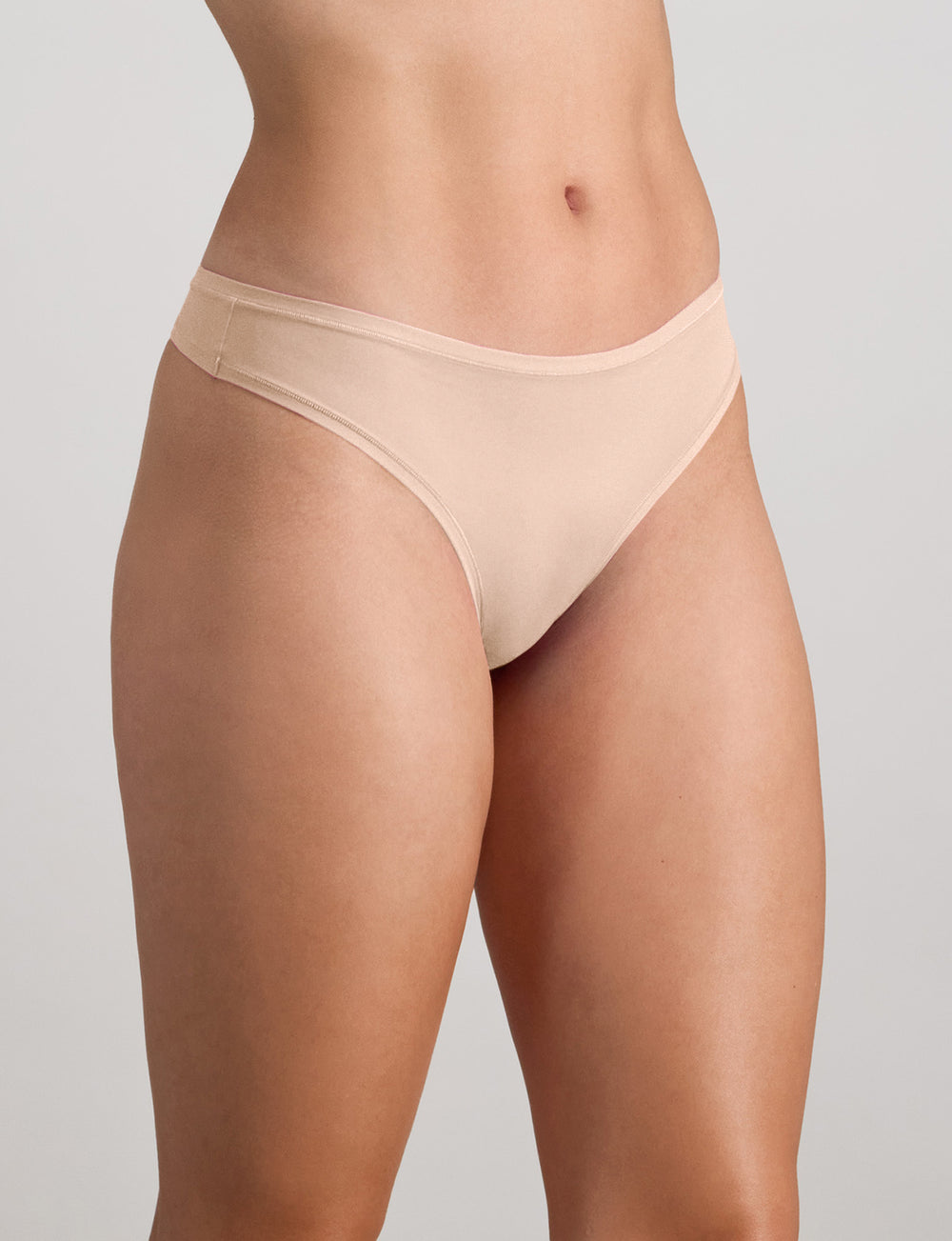 Model wears Extra-Ordinary Thong in LATTE. On body side view