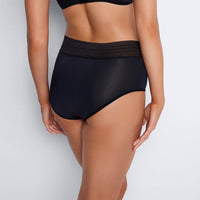 Model wears Flo Heavy Full Brief in BLACK. On body back view