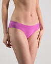 Model wears Seamless Soft Bikini in RADIANT ORCHID. On body side view