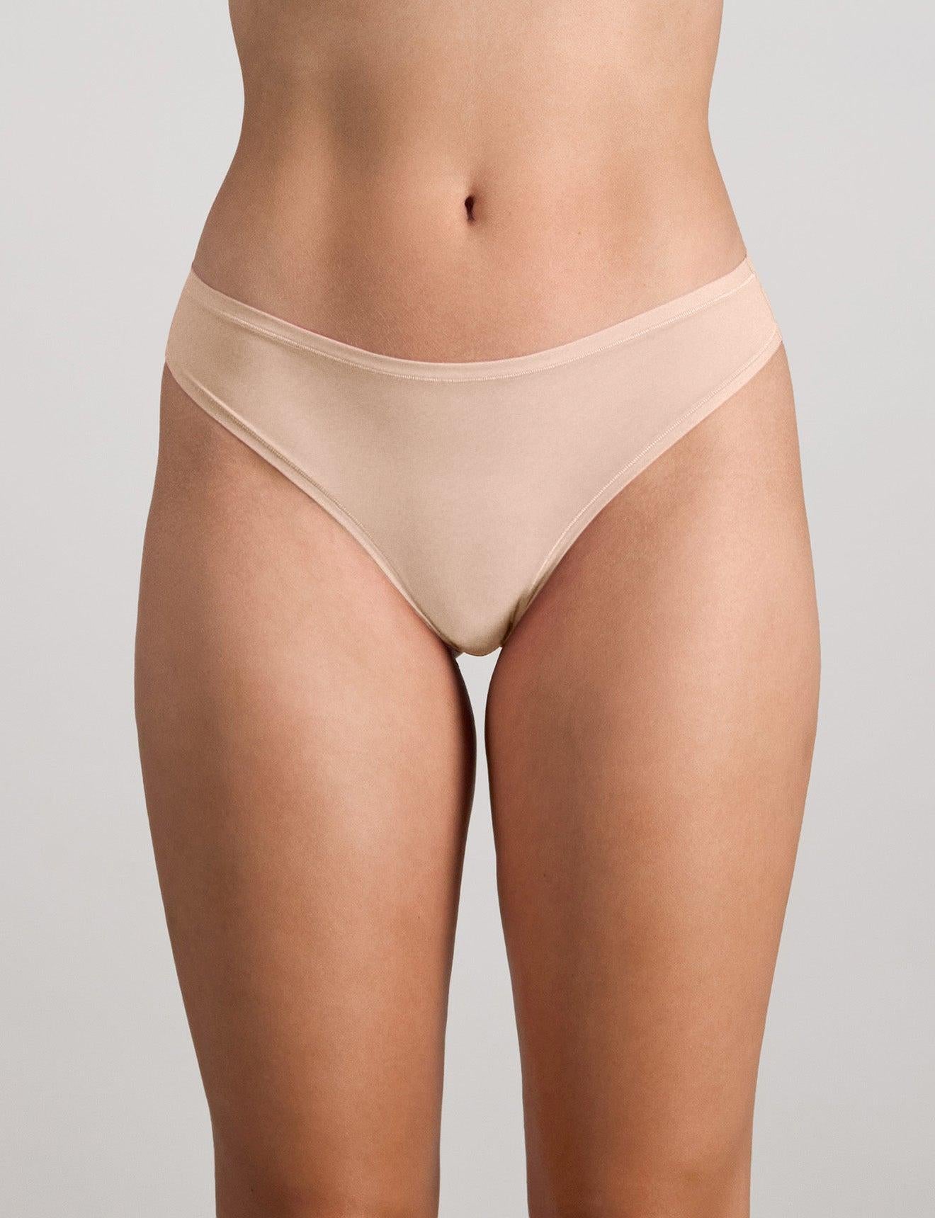 Model wears Extra-Ordinary Thong in LATTE. On body front view