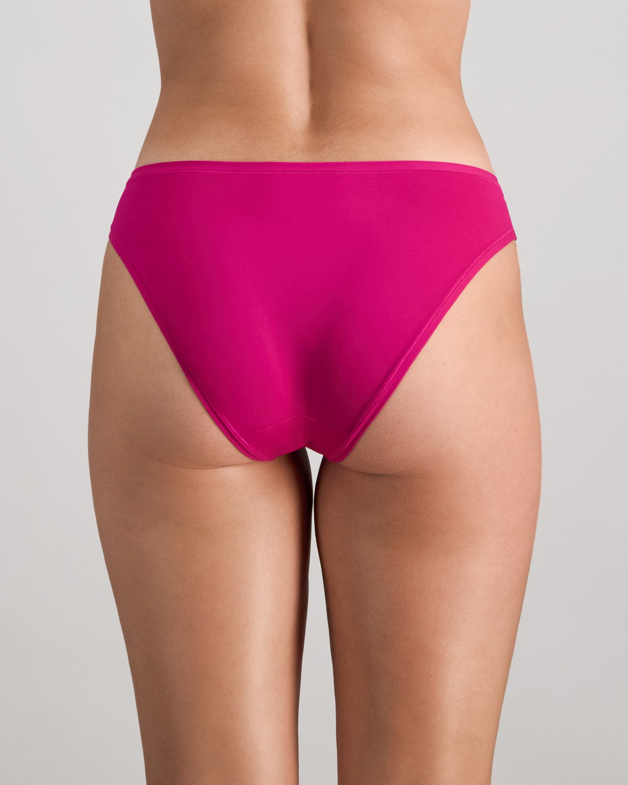 Model wears Extra-Ordinary Bikini in FANTASY FUCHSIA. On body back view