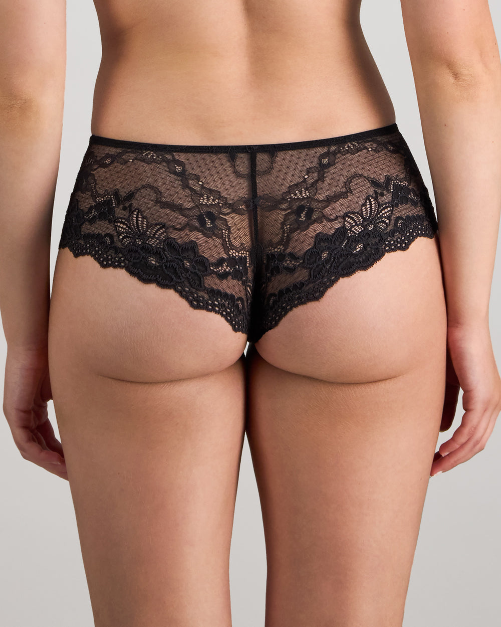 Model wears My Fit Lace Brazilian in BLACK. On body back view