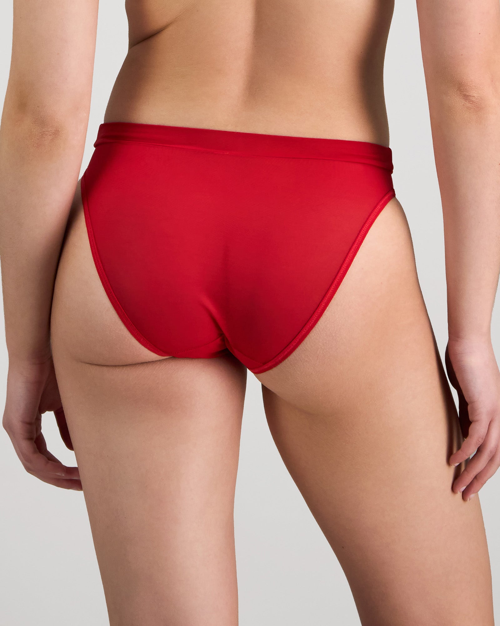 Model wears Lightweight High Cut Brief in SALSA. On body back view