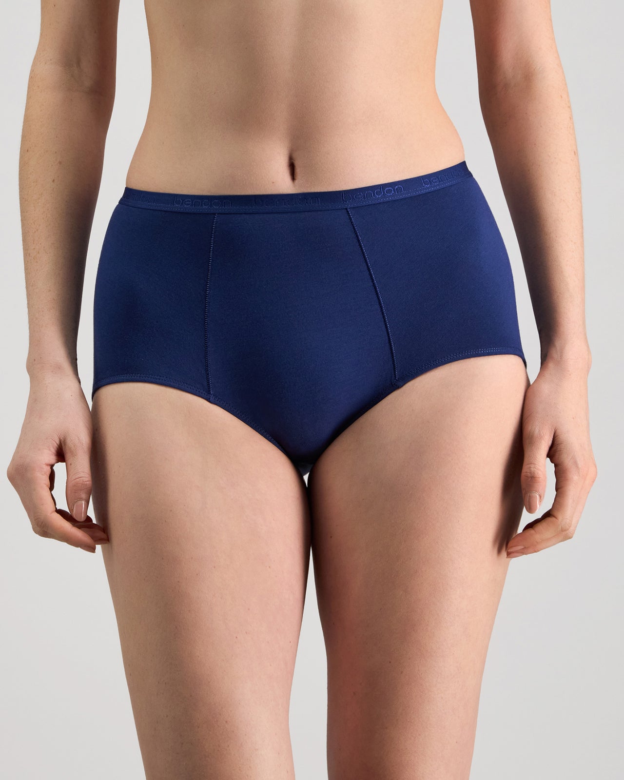 Model wears Body Cotton Full Brief in Medieval Blue. On body front view