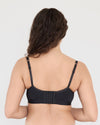 Model wears Castaway Contour Long Line Bra in BLACK. On body back view