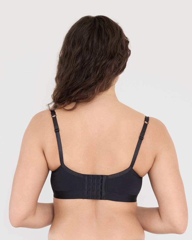 Model wears Castaway Contour Long Line Bra in BLACK. On body back view