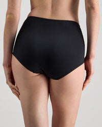 Model wears Freestyle Full Brief in BLACK. On body side view