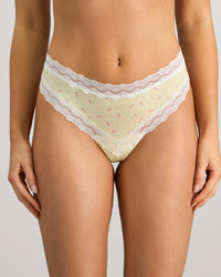 Model wears Daily Micro Thong in TRANSPARENT YELLOW. On body front view
