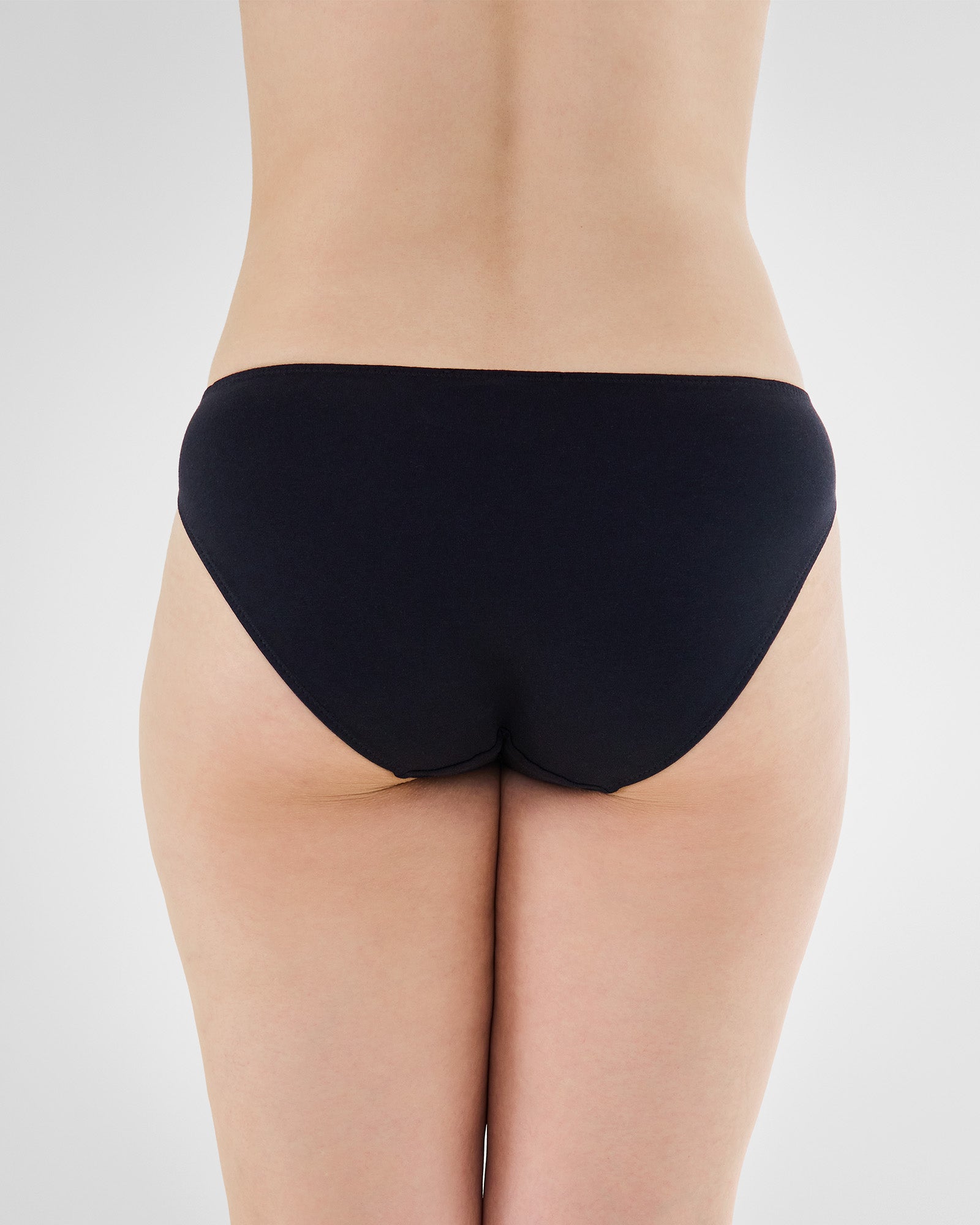 Model wears Embrace Bikini in BLACK. On body back view