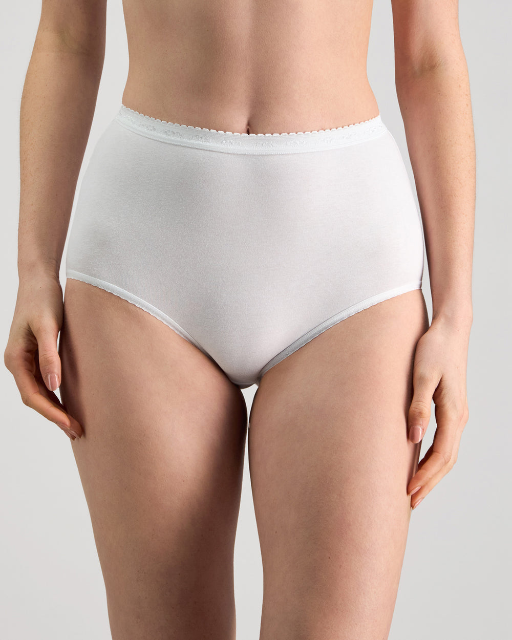 Model wears Freedom Full Brief in WHITE. On body front view