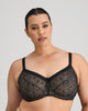 Model wears Delicate Lace Underwire Bra in BLACK/CREAM TAN. On body front view