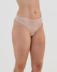 Model wears All Lacey Thong in LATTE. On body side view
