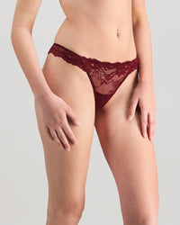 Model wears My Fit Lace Thong in WINDSOR WINE. On body side view