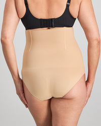 Model wears Medium Control High Waisted Brief in CARAMEL. On body back view
