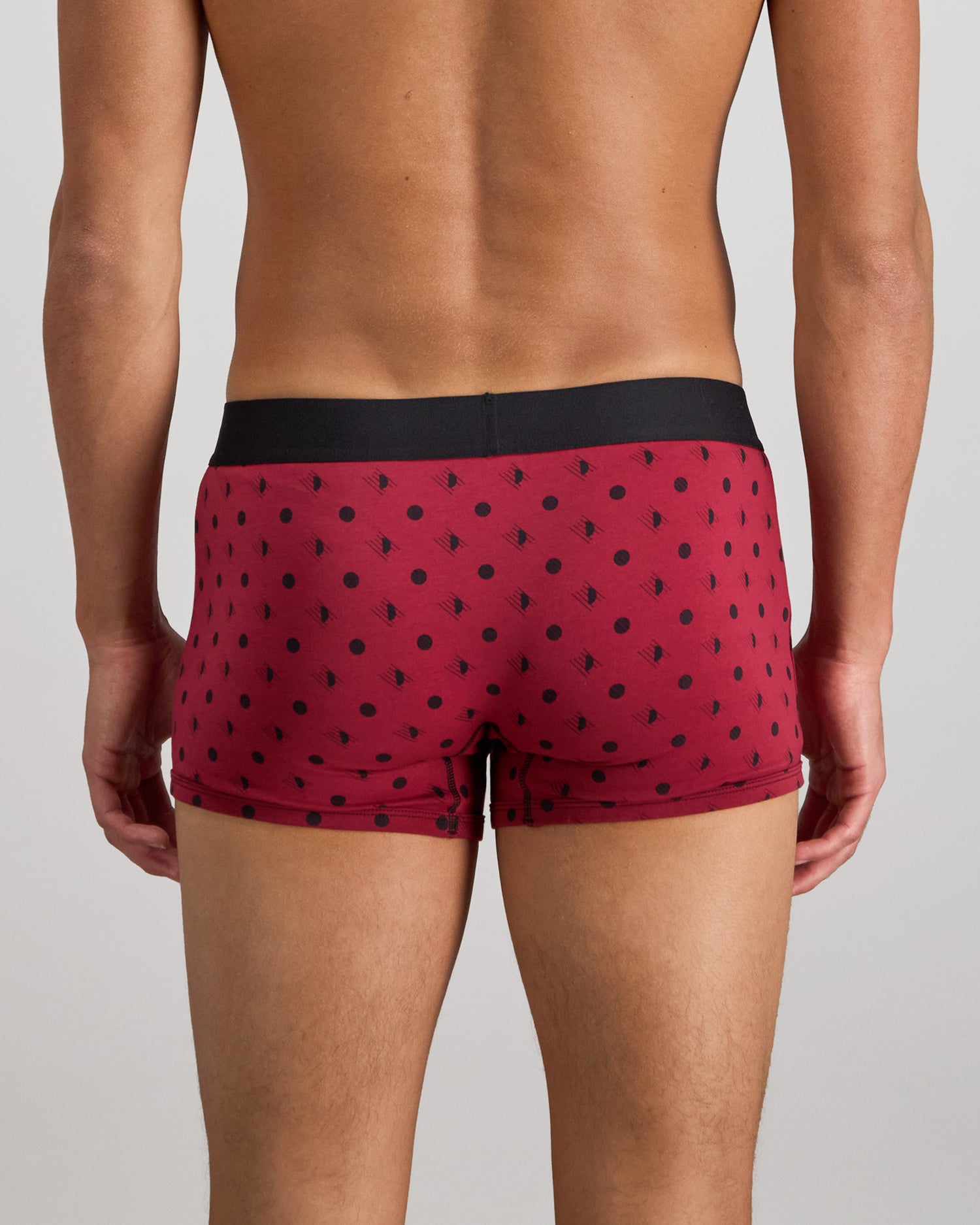 Model wears Retros Print Mens Trunk in DISRUPTED SPOT PRINT. On body back view