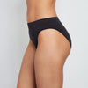 Model wears Seamless High Cut Brief in BLACK. On body side view