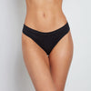 Model wears Seamless Thong in BLACK. On body front view