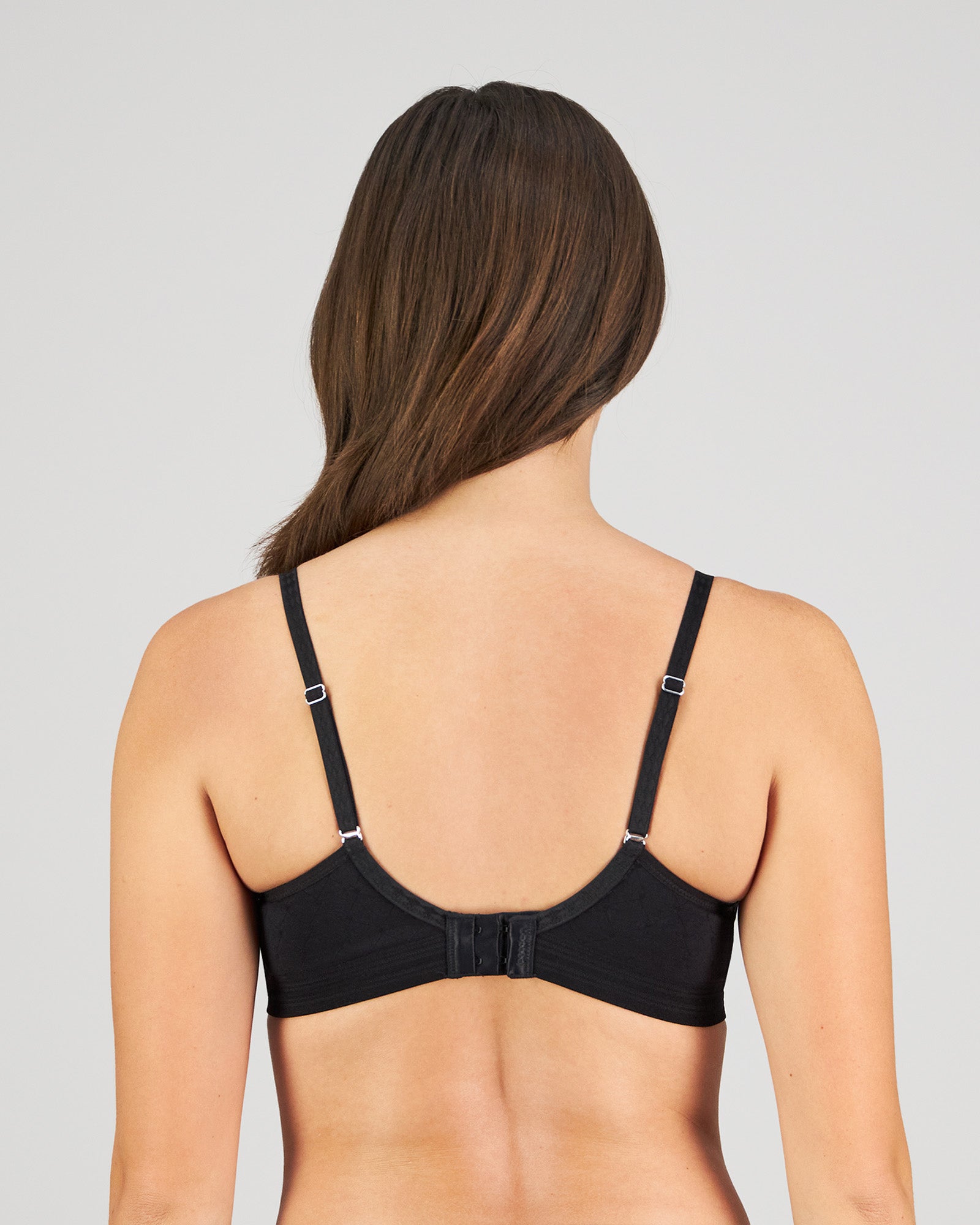 Model wears Bendon Body Lace Wire Free Bra in BLACK. On body back view