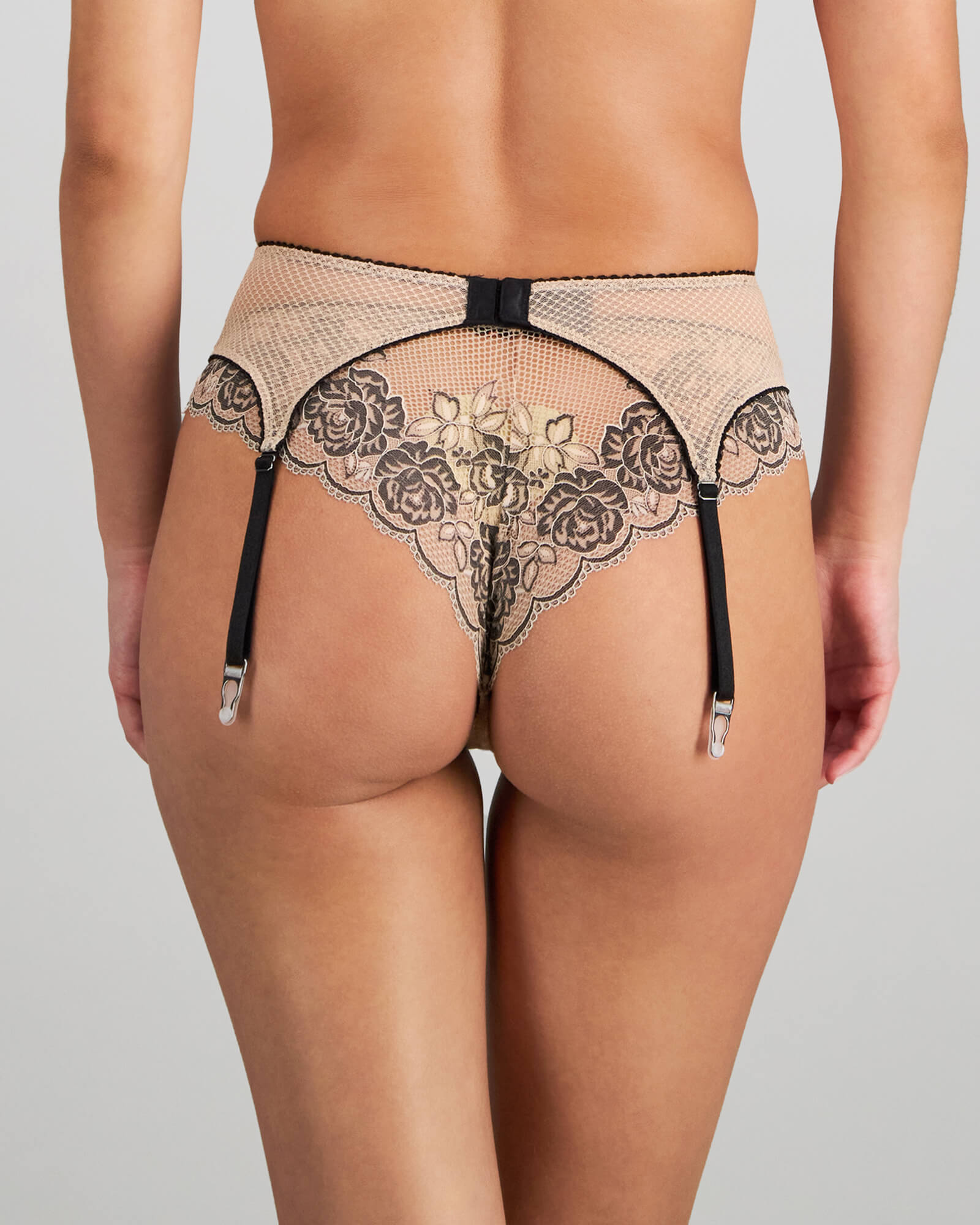 Model wears Everlasting Love Suspender in CAMEO ROSE / BLACK. On body back view
