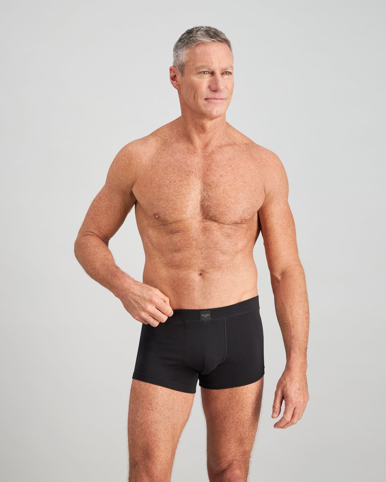 Model wears High Tech Cotton Mens Trunk in BLACK. On body front view