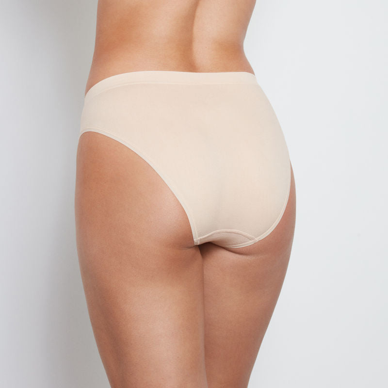 Model wears Seamless High Cut Brief in LATTE. On body back view